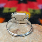 This colorful Zuni Inlay Ring features rectangular turquoise, black, and reddish-orange stone inlay in a geometric pattern, framed in silver with beaded accents along the sides; Sterling Silver stamp.