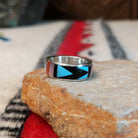 Zuni geometric inlay ring by Delberta Boone with turquoise, coral, shell, and dark stone.