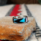 Zuni geometric inlay ring by Delberta Boone with turquoise, coral, shell, and dark stone.