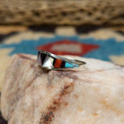Zuni inlay ring by Tammie Qualo, featuring precisely fitted natural stones set in a handcrafted sterling silver band with traditional Zuni craftsmanship.  Side view.