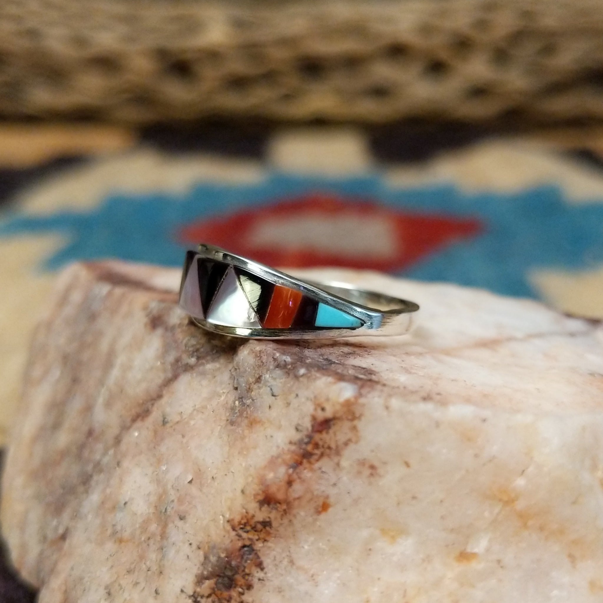 Zuni inlay ring by Tammie Qualo, featuring precisely fitted natural stones set in a handcrafted sterling silver band with traditional Zuni craftsmanship.  Side view.