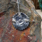 Zuni lapis cluster pendant and pin by Lorraine Waatsa featuring deep blue lapis stones arranged in concentric circles with twisted and sculptural silver detailing; artisan and tribe stamp.