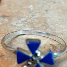 Zuni Lapis Dragonfly Ring featuring four triangular deep blue lapis lazuli inlay stones forming dragonfly wings, accented with sterling silver beads and a slender silver band; Zuni stamp.