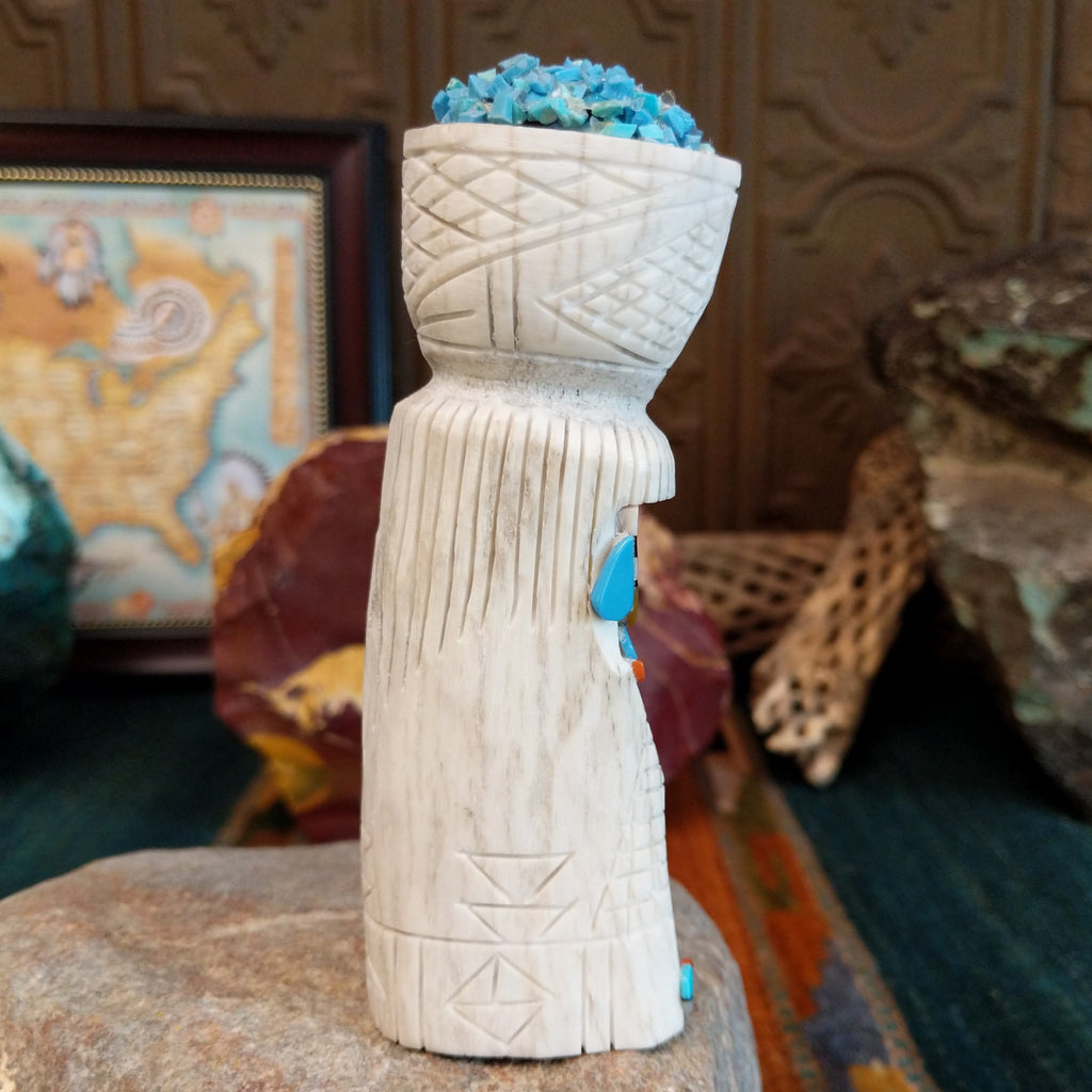 Zuni maiden fetish carving made from antler, with turquoise, mother of pearl, black onyx, and coral enhancing the carving's detailed texture.