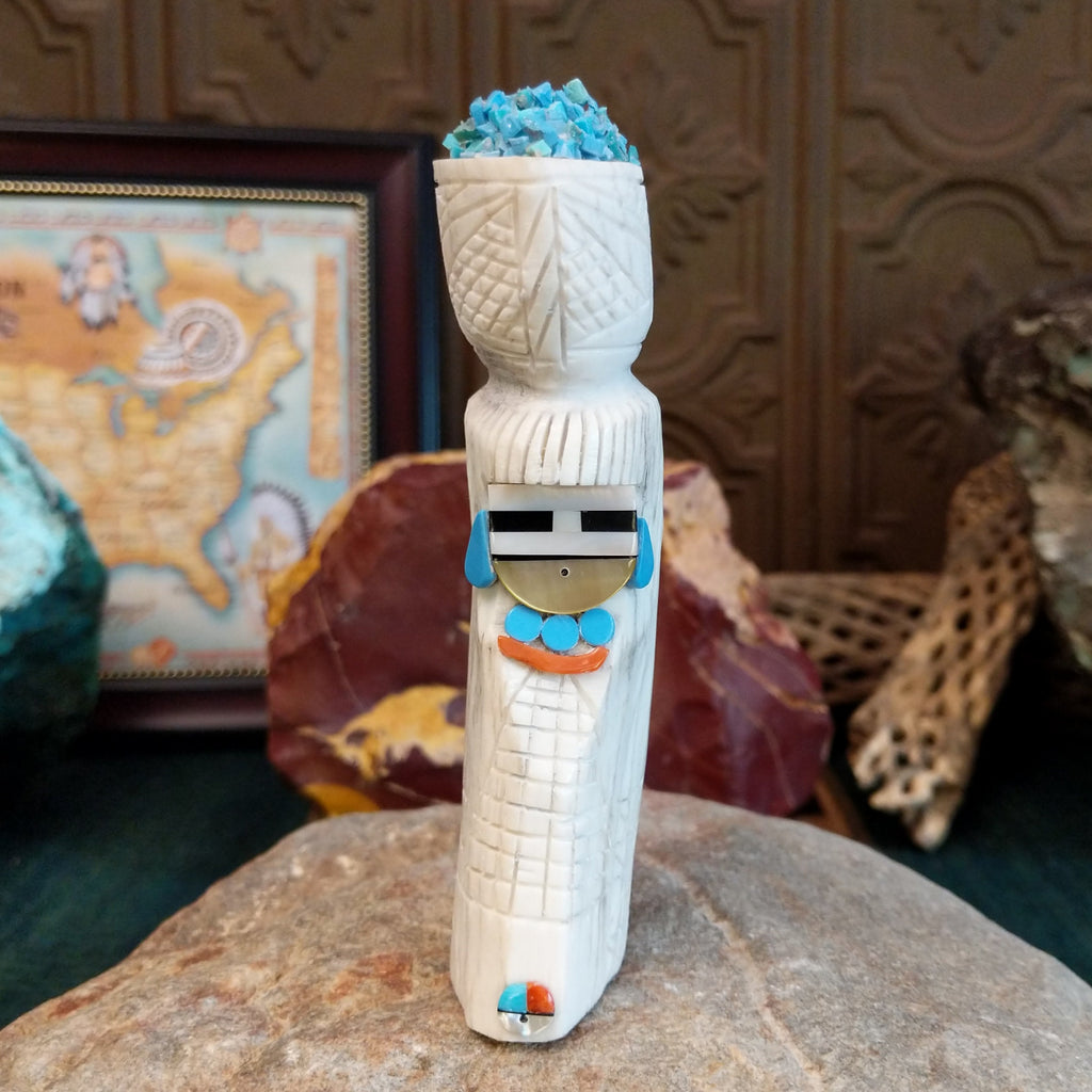 Zuni maiden fetish carving made from antler, with turquoise, mother of pearl, black onyx, and coral enhancing the carving's detailed texture.