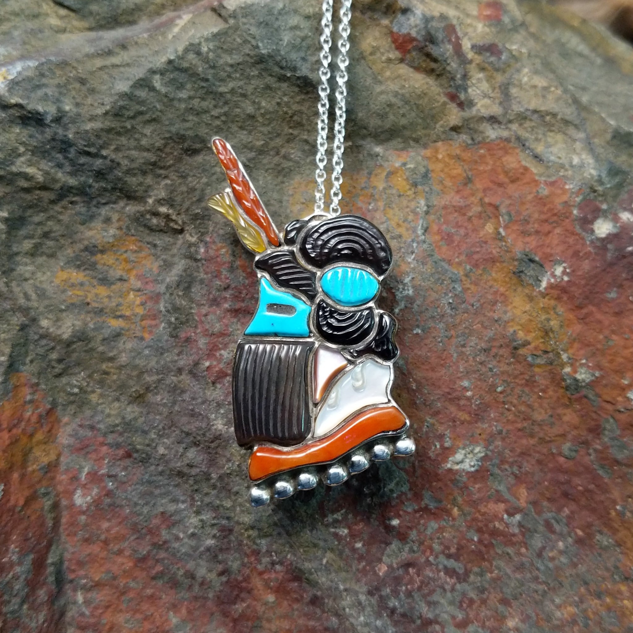 Handcrafted sterling silver Zuni Maiden pin and pendant by Andrea Shirley Lonjose, featuring intricate multistone inlay in a traditional Maiden design.