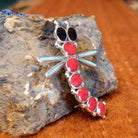 Sterling silver and red manmade opal, white manmade opal, and black onyx along the body of the dragonfly pendant.