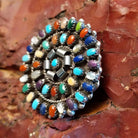 Round multi-stone pendant with vibrant colors and twisted rope accents.