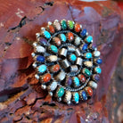 Round multi-stone pendant with vibrant colors and twisted rope accents.