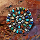 Round multi-stone pendant with vibrant colors and twisted rope accents.