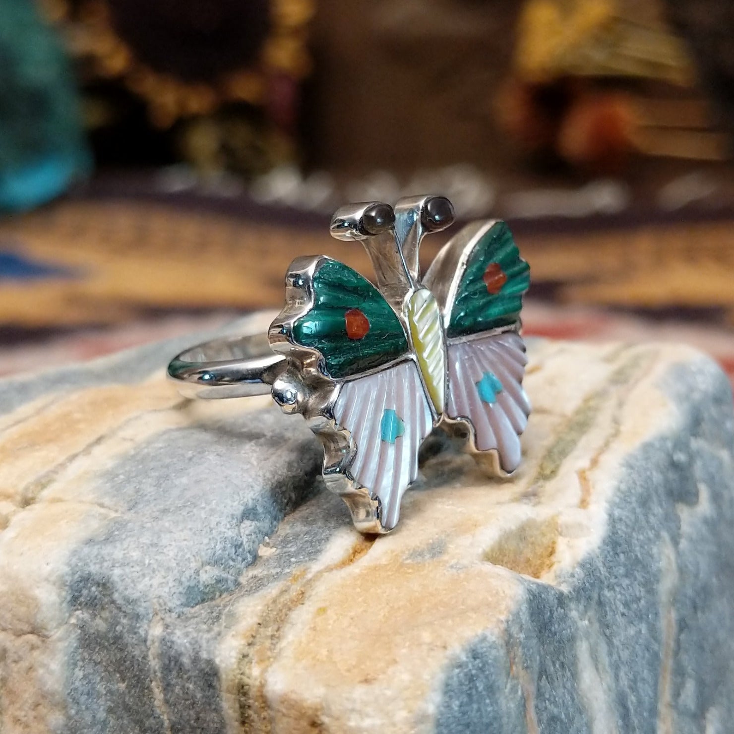 Handcrafted Zuni sterling silver butterfly ring featuring colorful multistone inlay work in a traditional Southwestern Native American design.  Side view.