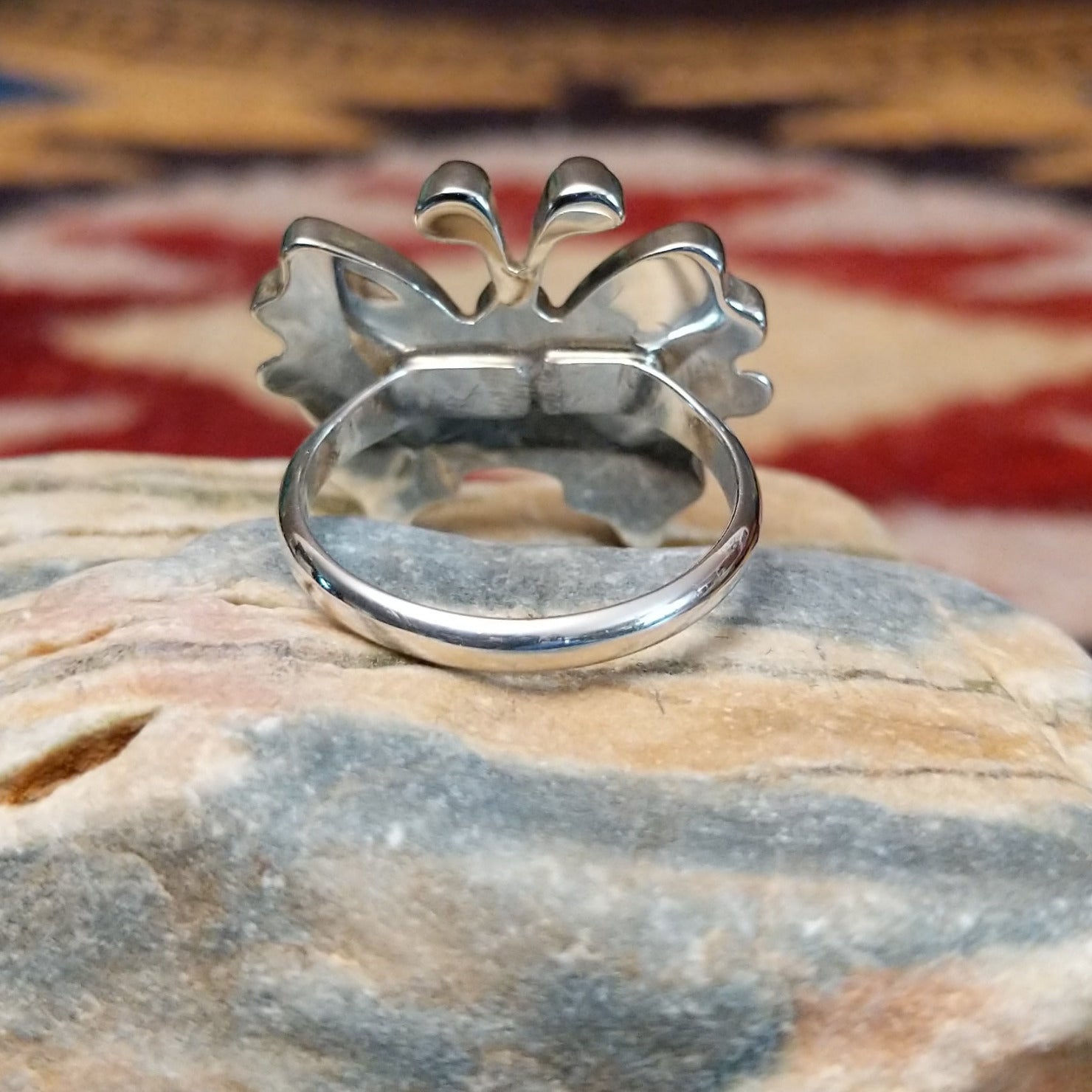 Handcrafted Zuni sterling silver butterfly ring featuring colorful multistone inlay work in a traditional Southwestern Native American design.  Underside view.
