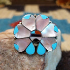 Sterling silver ring with multistone inlay of pink mussel shell, turquoise, black onyx, and coral.