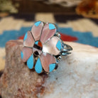 Sterling silver ring with multistone inlay of pink mussel shell, turquoise, black onyx, and coral.