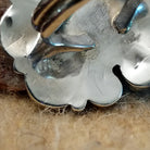 Close-up of the artisan's stamped signature.