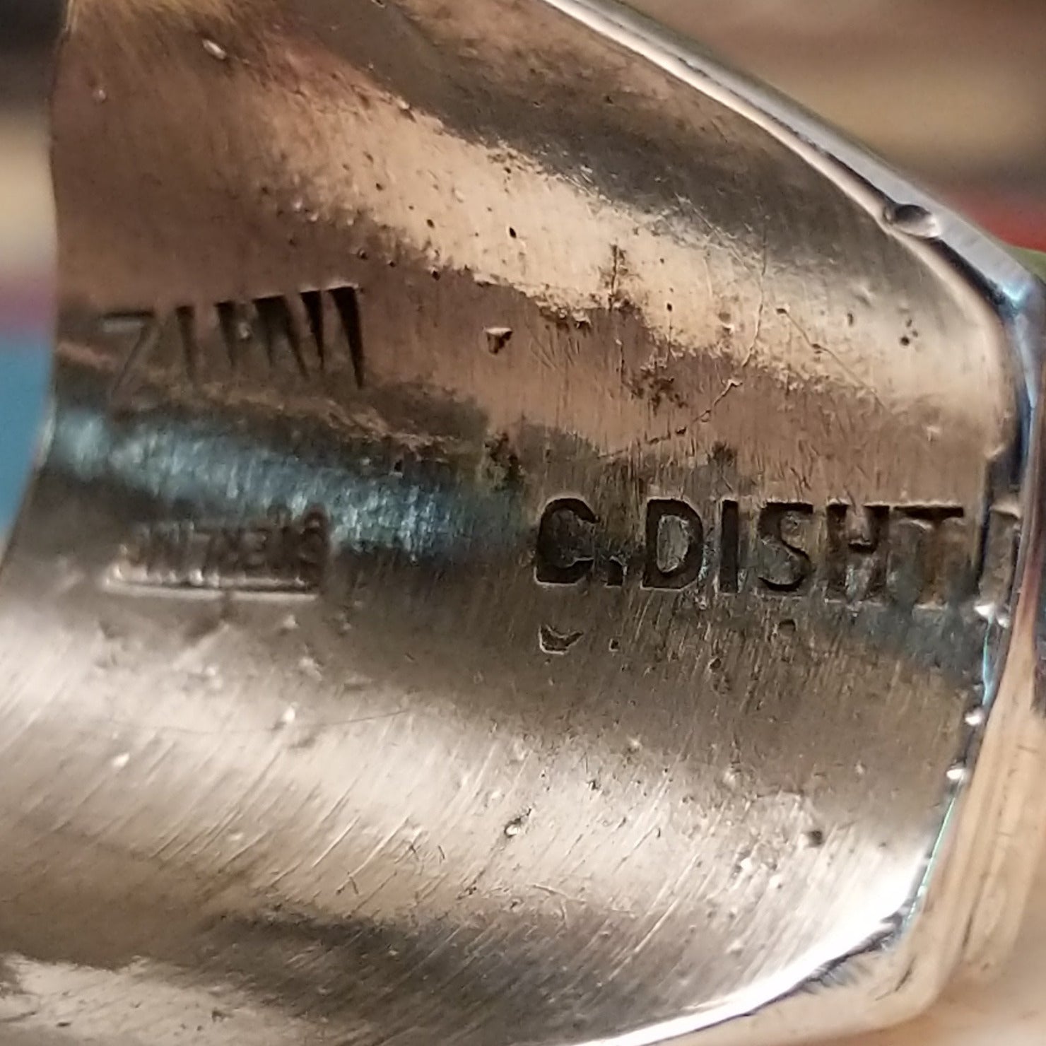 Close-up of the artisan's stamped signature.