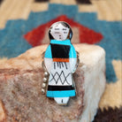 Sterling silver ring with maiden motif featuring turquoise, black onyx, coral, and mother of pearl.