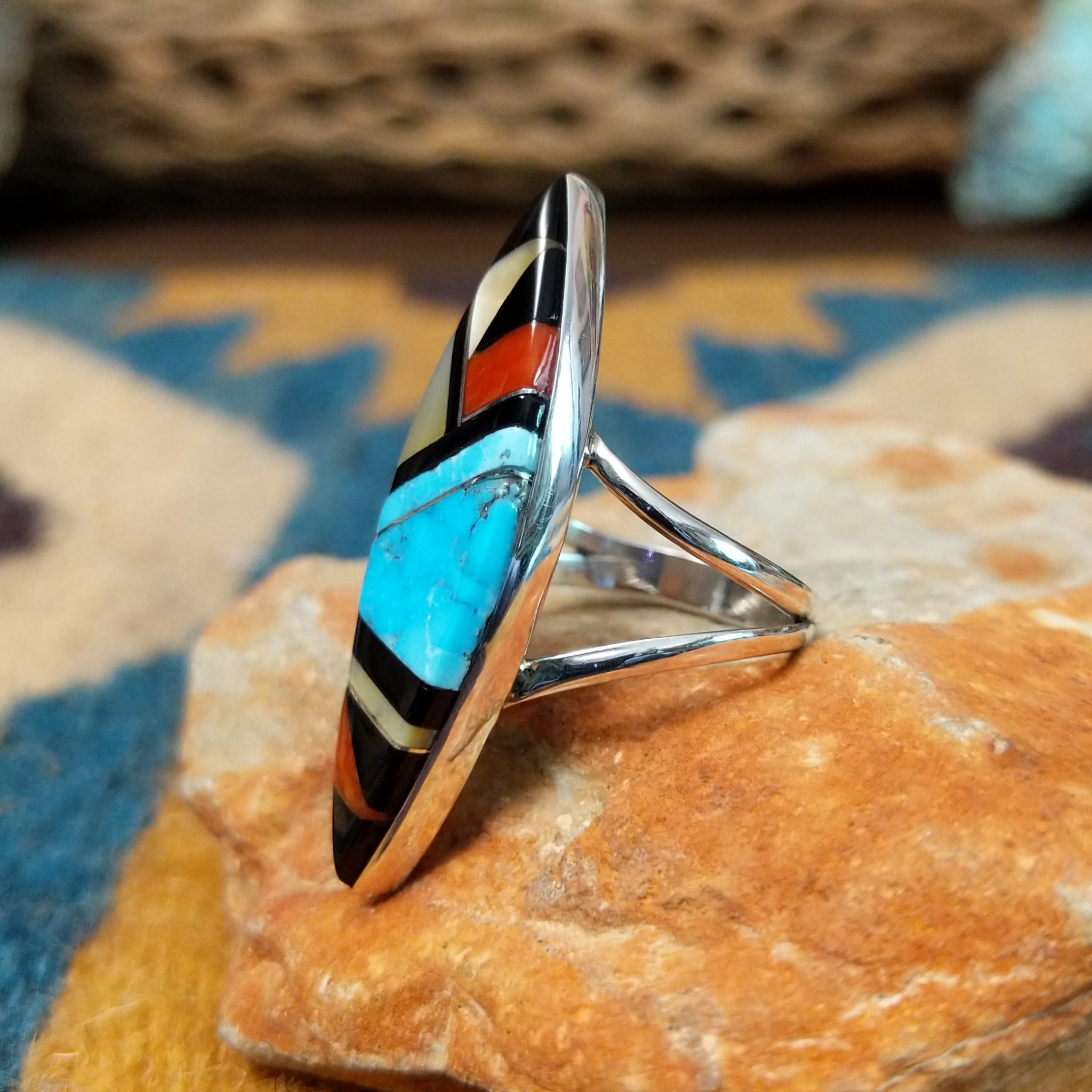 Handcrafted sterling silver Zuni multistone navette ring by Cleo Kallestewa, featuring a geometric inlay; side view.
