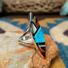 Handcrafted sterling silver Zuni multistone navette ring by Cleo Kallestewa, featuring a geometric inlay; side view.