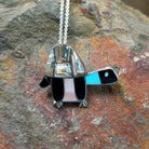 Handcrafted sterling silver multistone turtle pin and pendant by Lorretta, featuring traditional Zuni stone inlay in a turtle design.