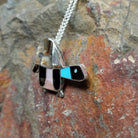 Handcrafted sterling silver multistone turtle pin and pendant by Lorretta, featuring traditional Zuni stone inlay in a turtle design; side view.