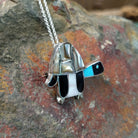 Handcrafted sterling silver multistone turtle pin and pendant by Lorretta, featuring traditional Zuni stone inlay in a turtle design; side view.
