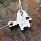 Handcrafted sterling silver multistone turtle pin and pendant by Lorretta, featuring traditional Zuni stone inlay in a turtle design; artisan signature.