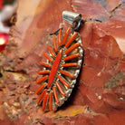Sterling silver pendant with coral needlepoint design.
