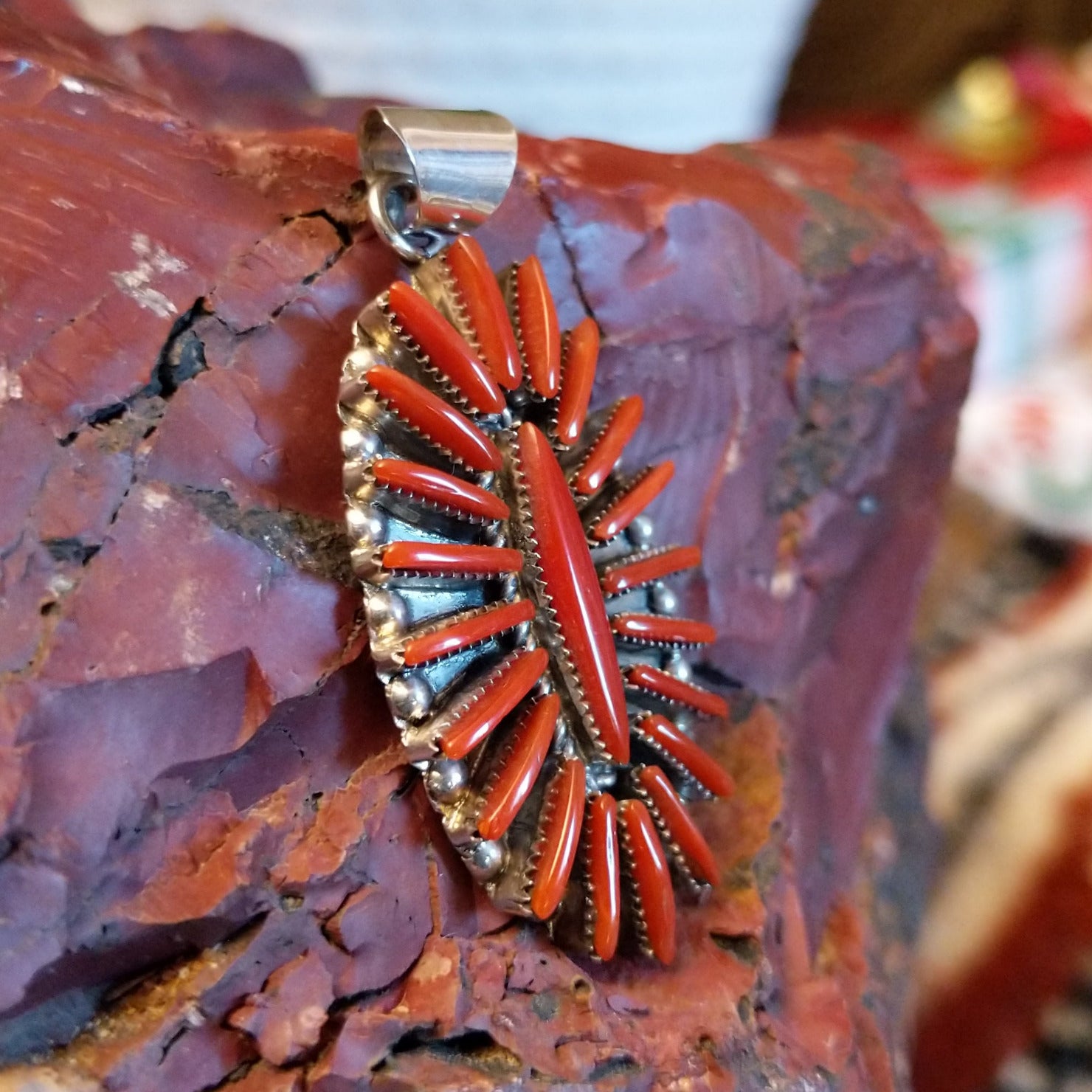 Sterling silver pendant with coral needlepoint design.