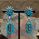 Handcrafted sterling silver Zuni needlepoint turquoise concho earrings by Connie Wyaco, featuring a two-piece dangle design with vibrant turquoise needlepoint.
