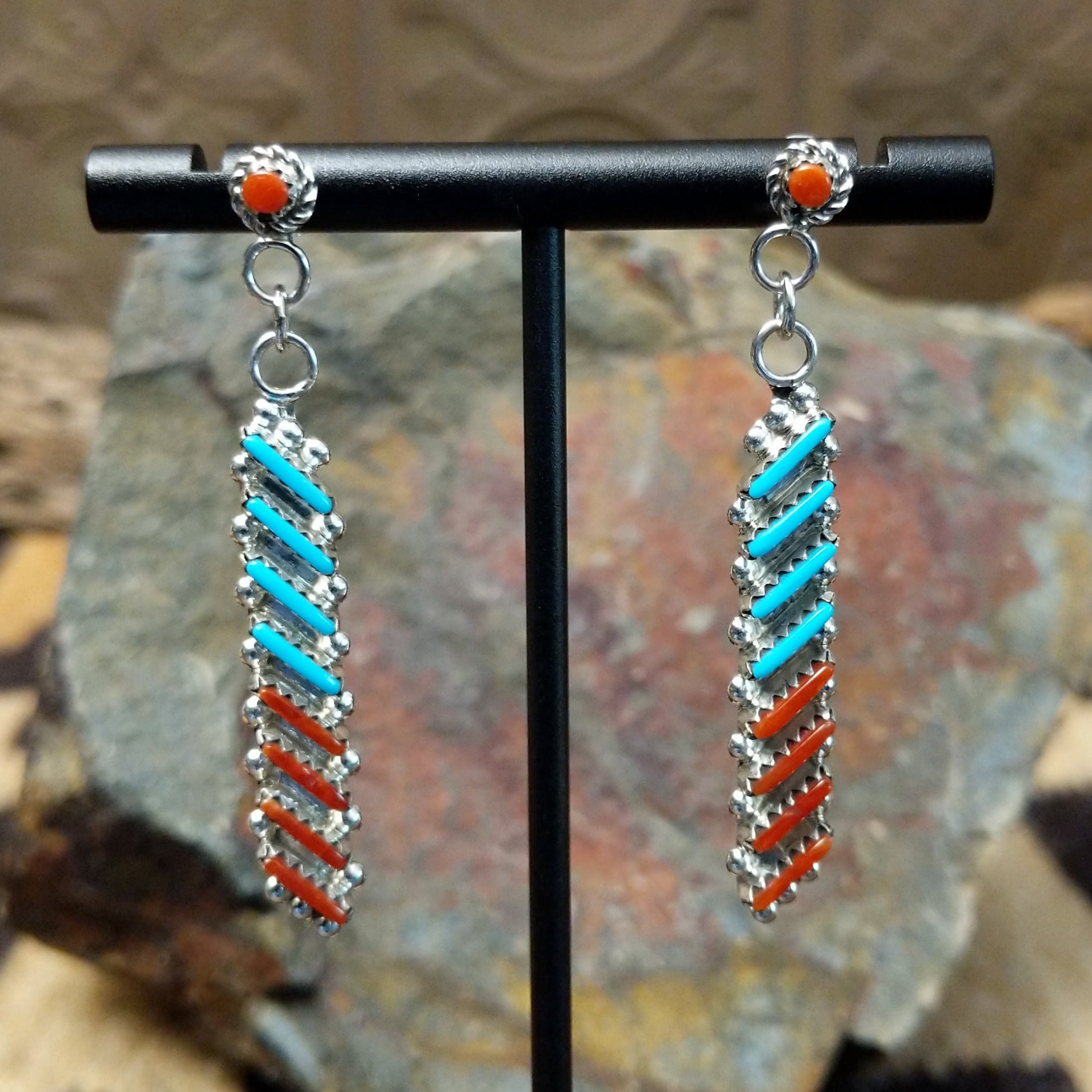 Handcrafted sterling silver Zuni turquoise and coral needlepoint earrings by Lamar Peywa, featuring elongated dangle inlay with coral stud tops.