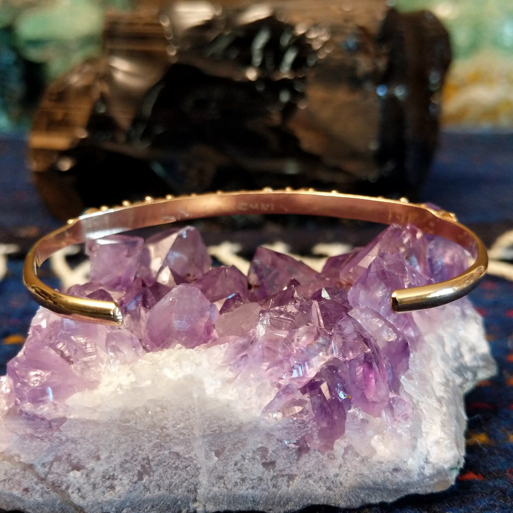 The back of the polished gold cuff.