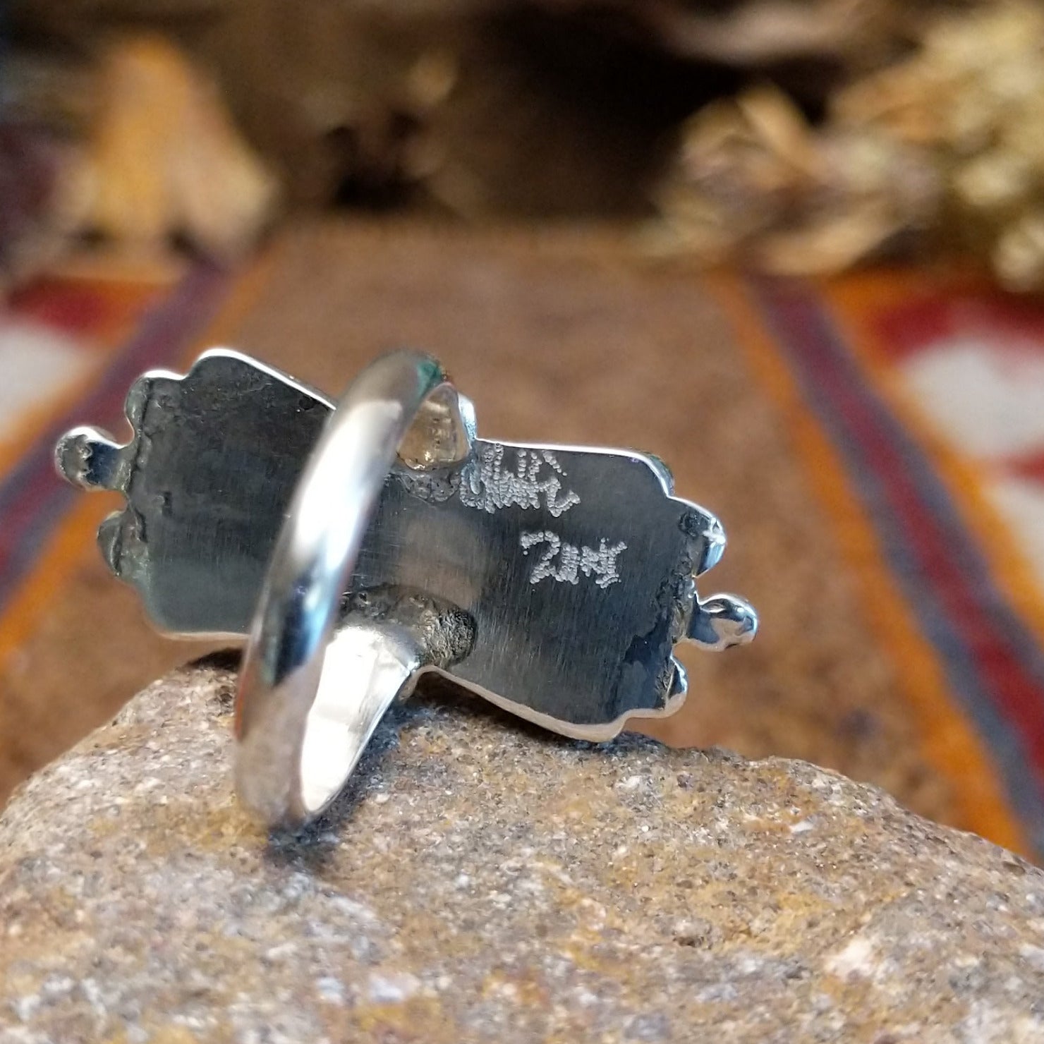 Close-up of the artisan's engraved signature.