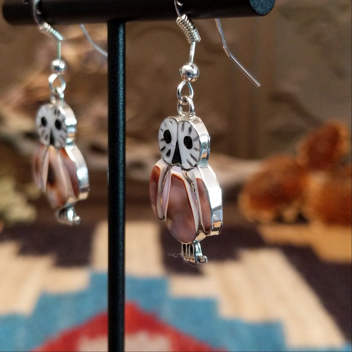 Sterling silver owl earrings with cowry shell, black onyx, and mother of pearl inlaid on the bezels.
