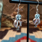 Sterling silver owl earrings with cowry shell, black onyx, and mother of pearl inlaid on the bezels.