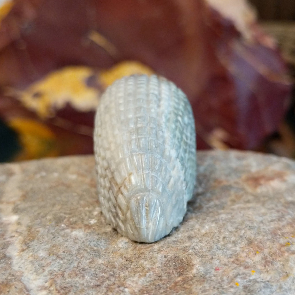 Picasso marble carved into a porcupine fetish with intricate etched details.