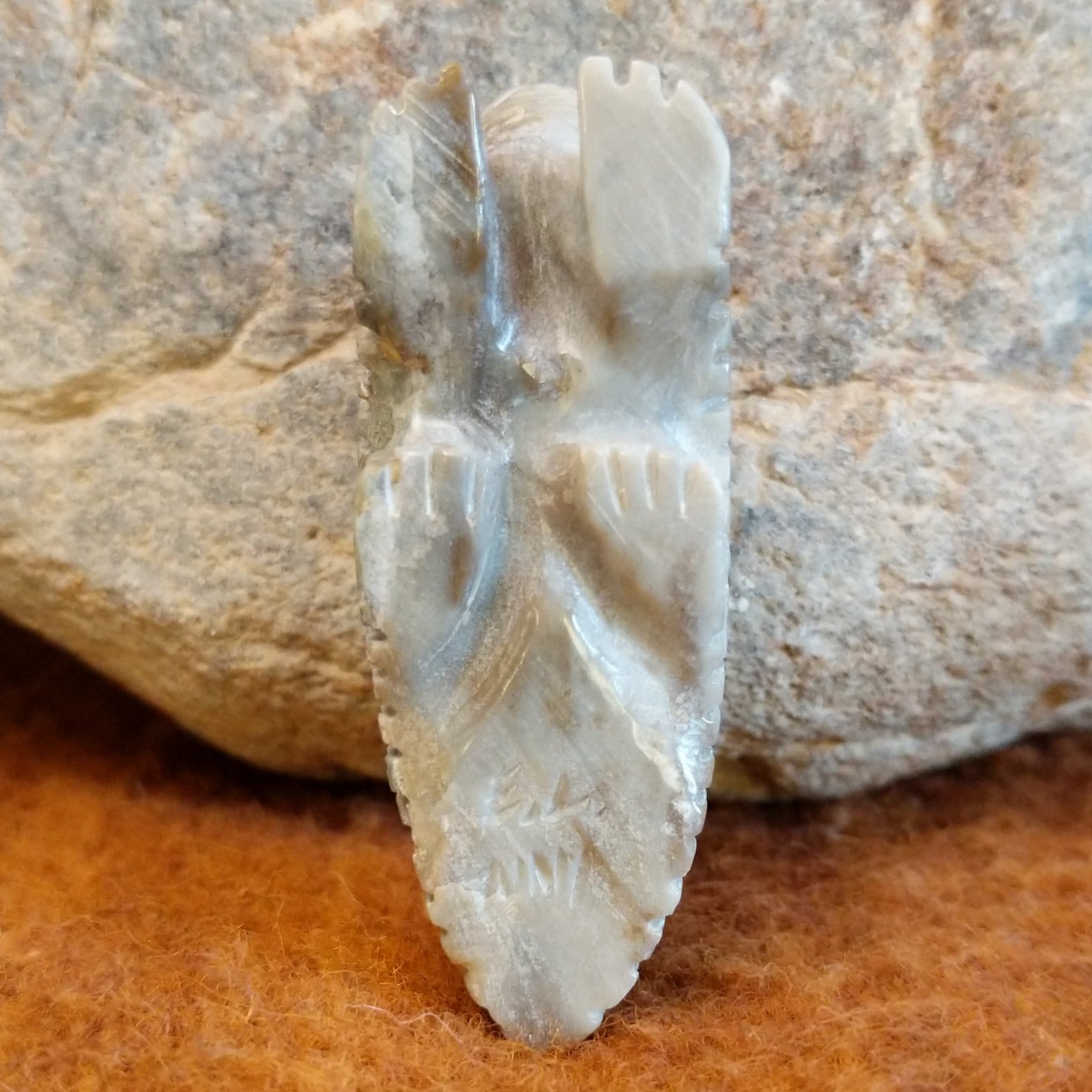 The artisan's signature is etched on the bottom of the fetish carving.