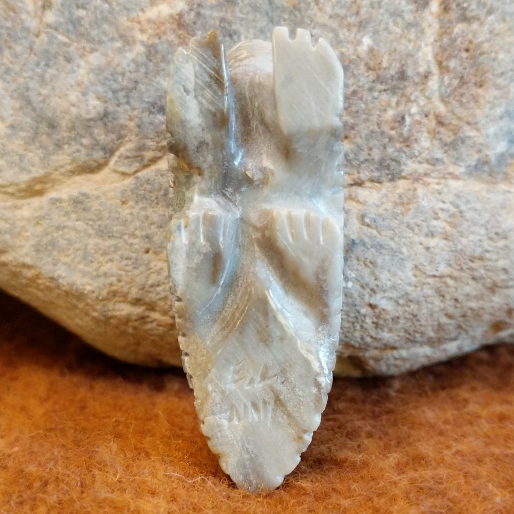 The artisan's signature is etched on the bottom of the fetish carving.