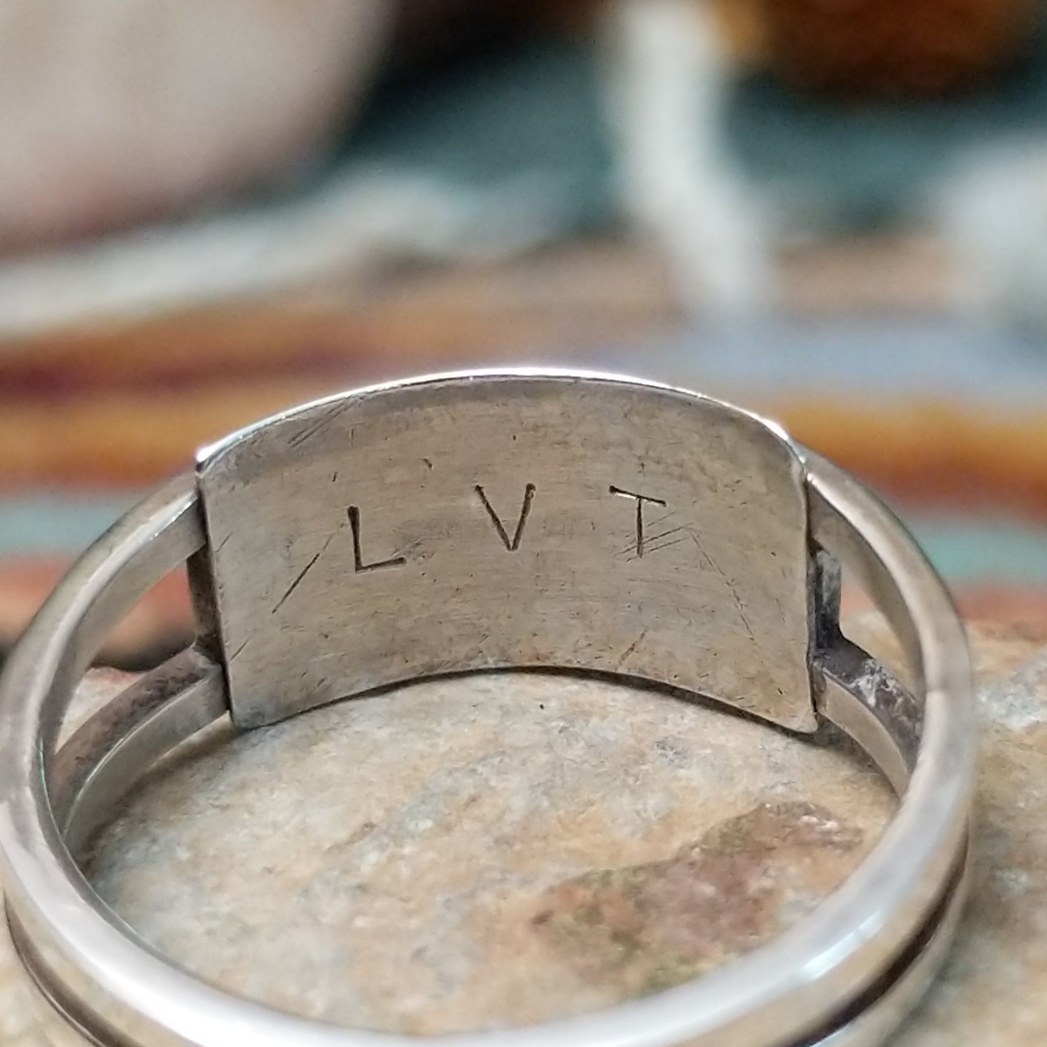 Zuni sterling silver ring by Lindsay Von-Tsalate featuring raised coral inlay with silver dividers in a polished open-band setting; artisan stamp.