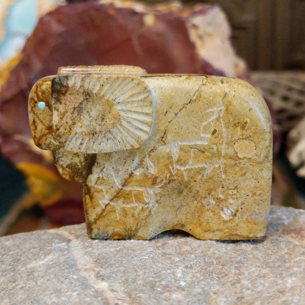 Picasso marble carved into a ram with etched motifs on the body.