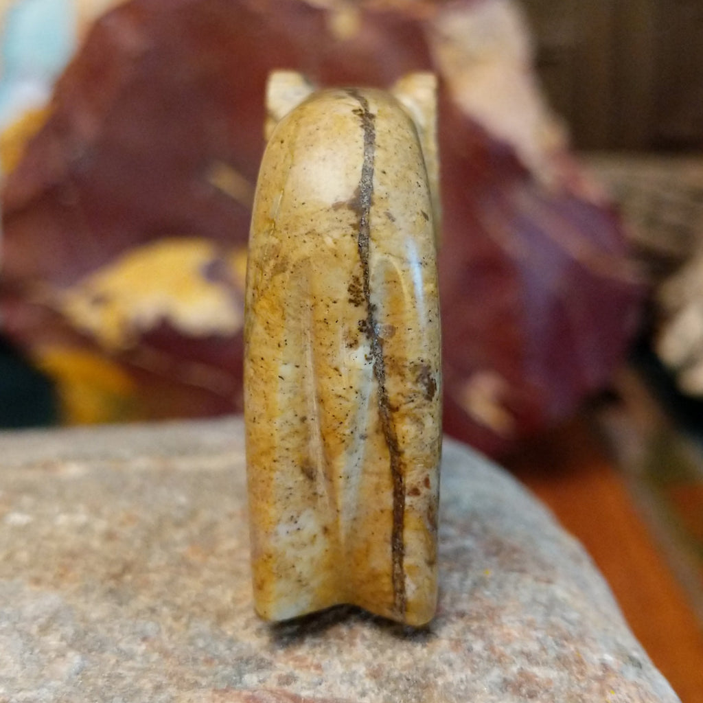 Picasso marble carved into a ram with etched motifs on the body.