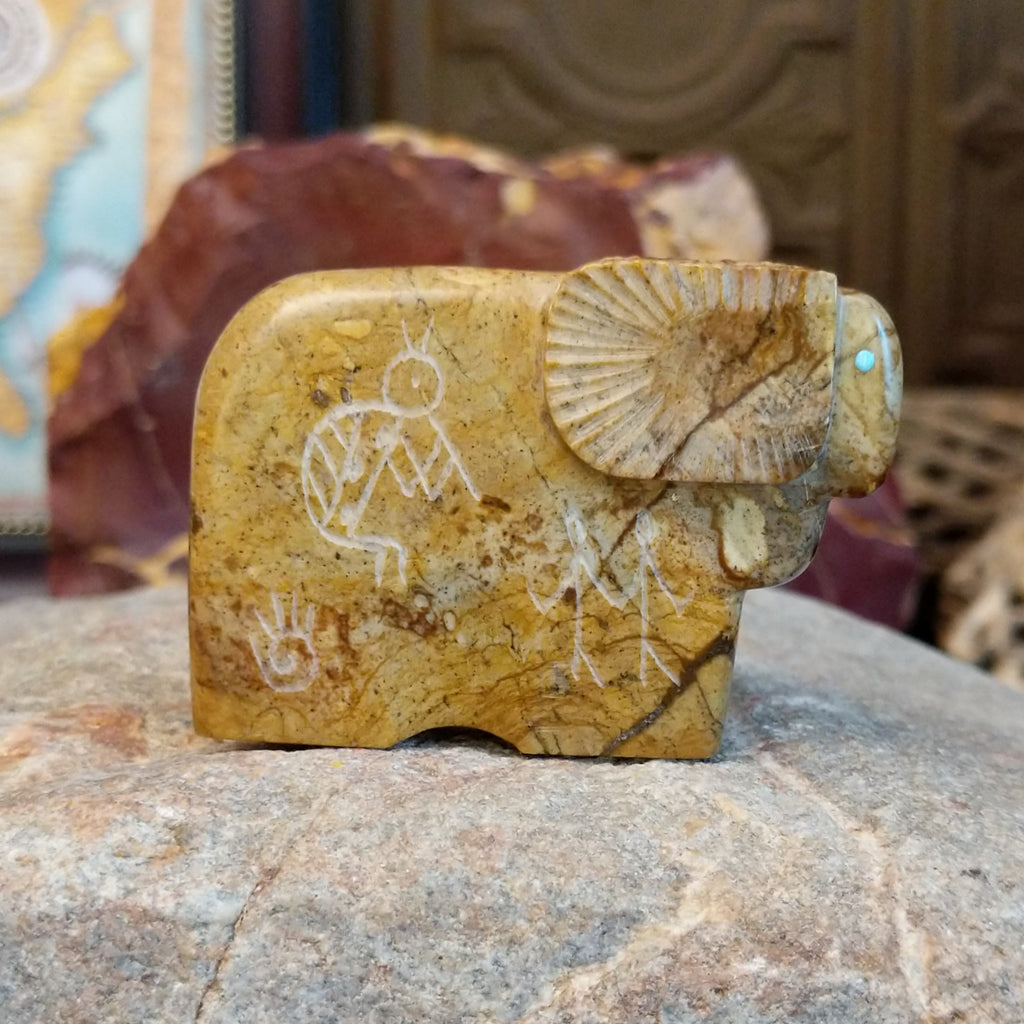 Picasso marble carved into a ram with etched motifs on the body.