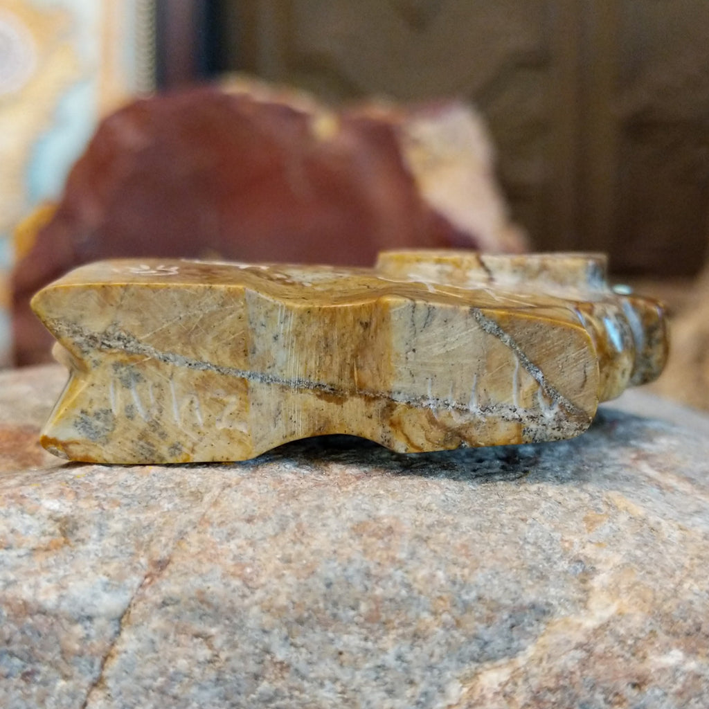 The underside of the fetish carving features the artisan's signature on the bottom.