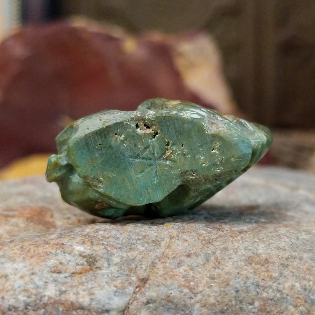 The underside features the etched signature of the artisan.