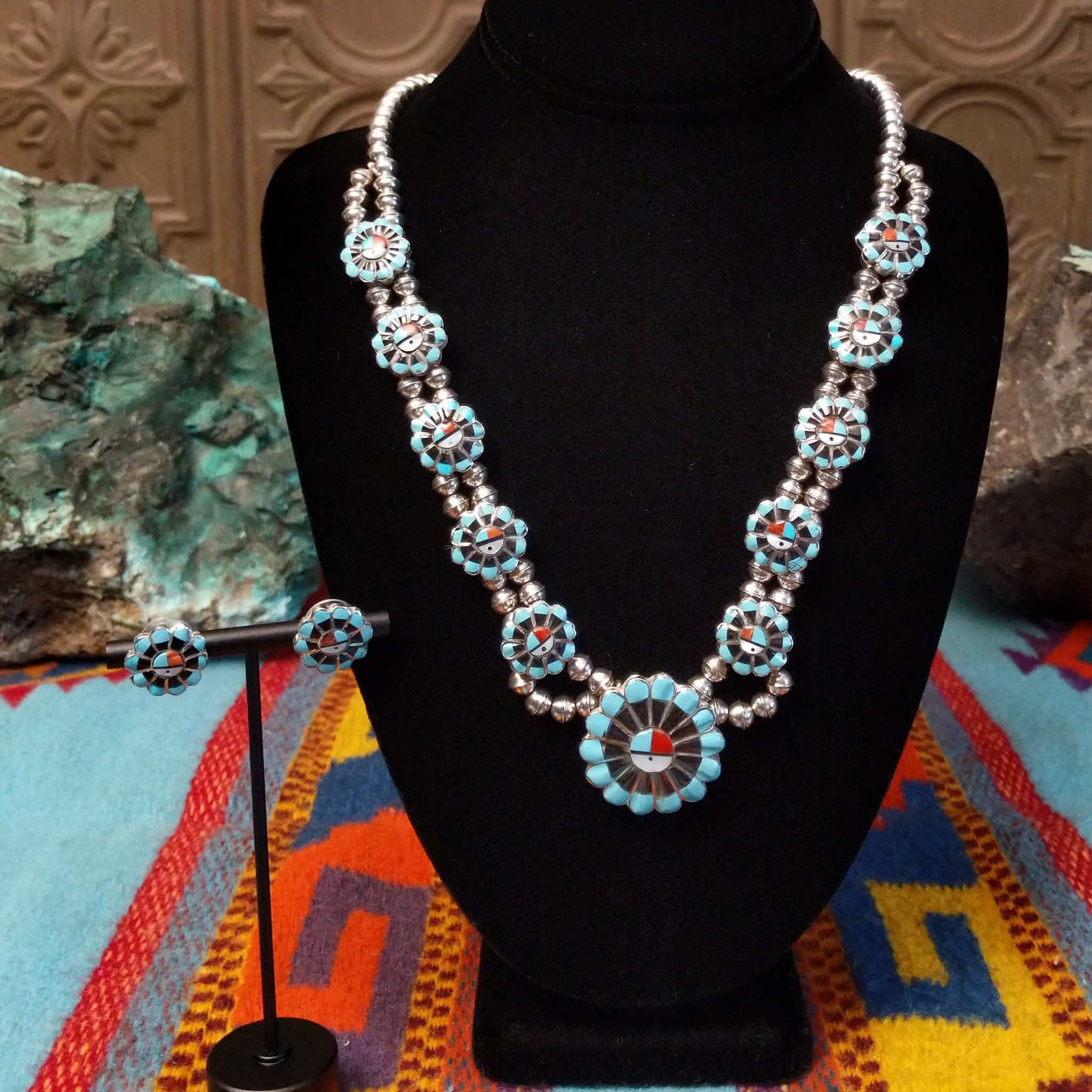 Zuni Sunface Sterling Silver necklace and matching earrings by Marisa Selecion, featuring turquoise, coral, black onyx, and mother of pearl, with detailed Sunface designs.