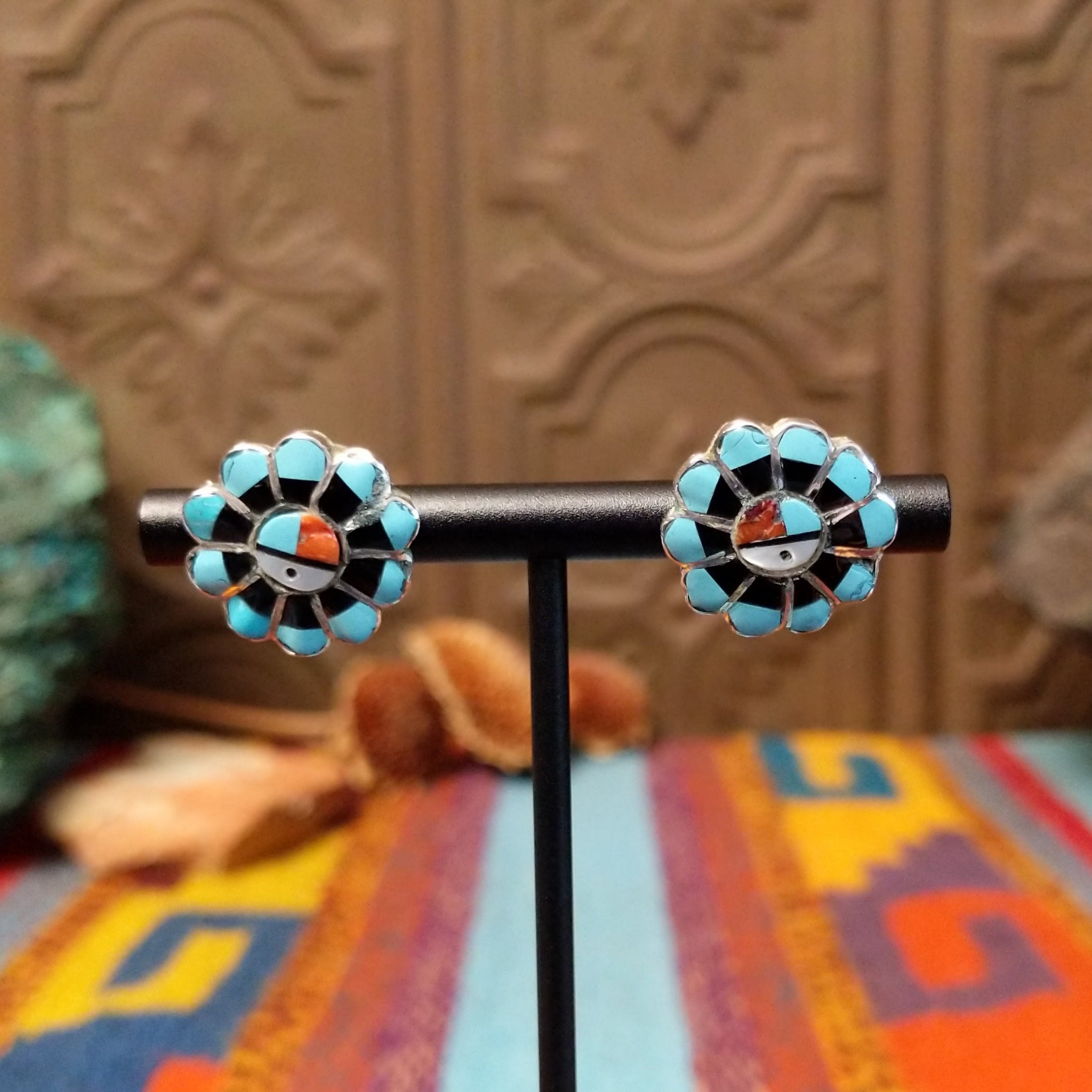 Zuni Sunface Sterling Silver earrings by Marisa Selecion, featuring turquoise, coral, black onyx, and mother of pearl, with detailed Sunface designs.