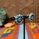 Zuni Sunface Sterling Silver earrings by Marisa Selecion, featuring turquoise, coral, black onyx, and mother of pearl, with detailed Sunface designs; side view.