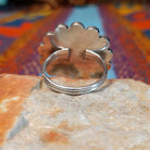 Zuni Sunface Ring by Annie Willie featuring an intricate multicolor inlay Sunface design with turquoise, black, red, and cream-colored accents set in Sterling Silver; underside view.