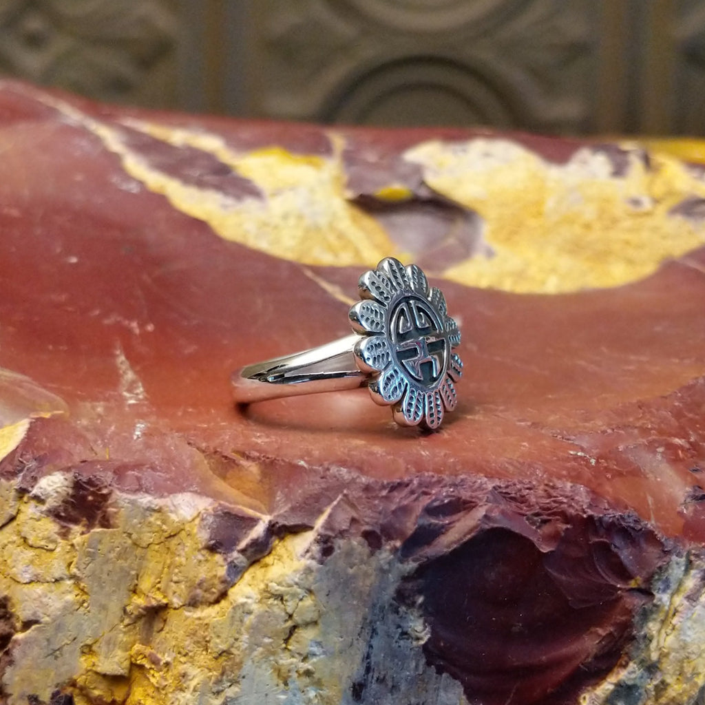 Detailed Sunface motif as the sterling silver ring's centerpiece.