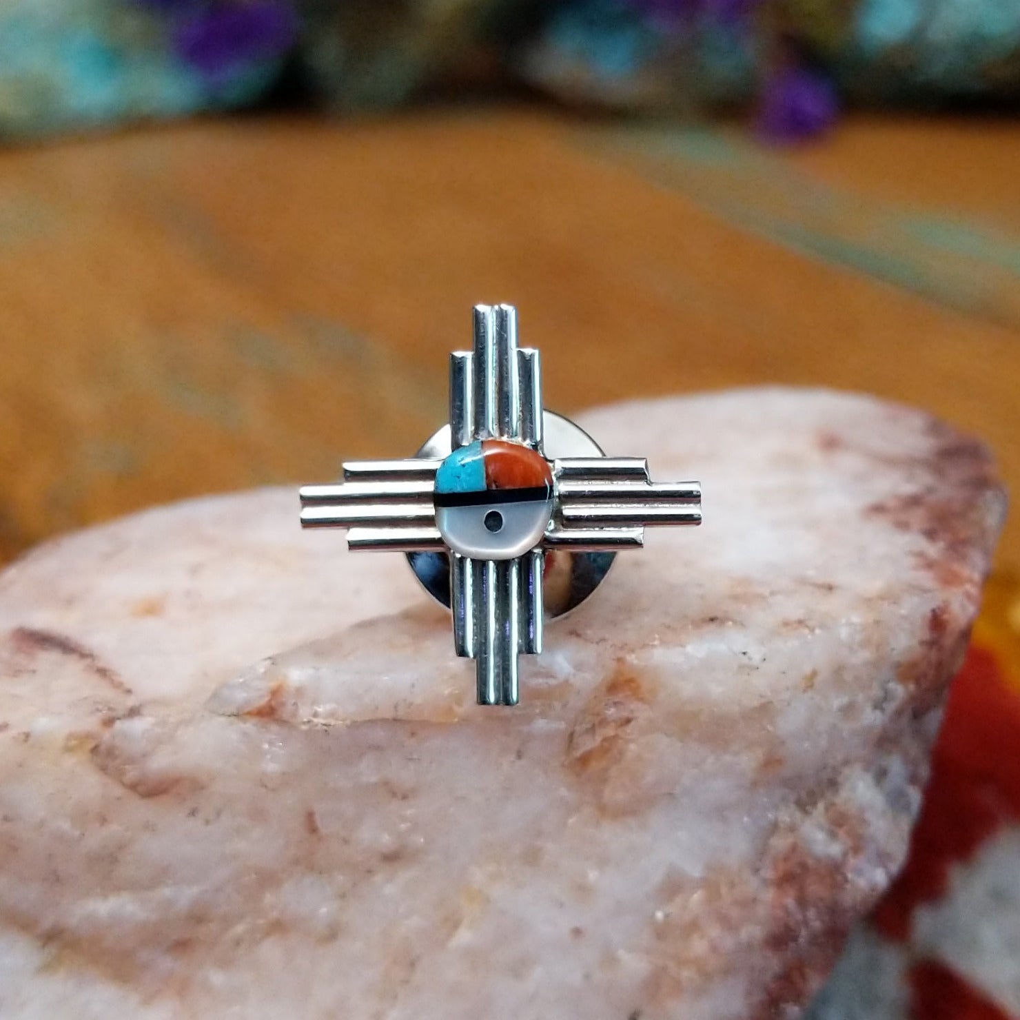 Sterling silver Zuni tie tack with sun symbol-inspired design and multistone center.